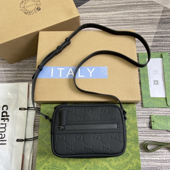 Gucci men's black rubber-effect mini shoulder bag with presentation packaging Gucci men's black rubber-effect mini shoulder bag laid flat with branded packaging boxes and dust bag elements