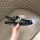 Gucci Black Sandals Outer View in black and gold Handheld angle showing the outer side of the black Gucci sandals in black and gold